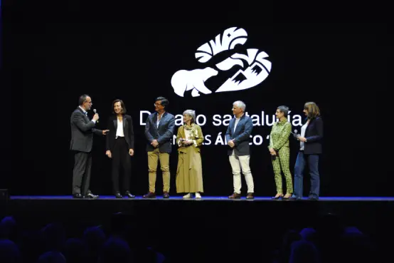 Presentación en escenario del documental Desafío Santalucía Seniors con varias personas dialogando ante el logotipo corporativo sobre fondo negro